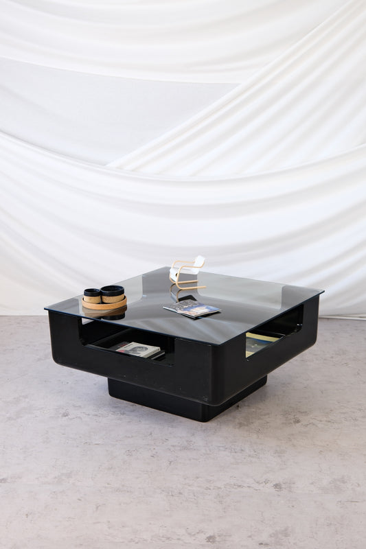 Eero Aarnio black fiberglass coffee table with smoked glass top and integrated storage, 1970s Finnish design.