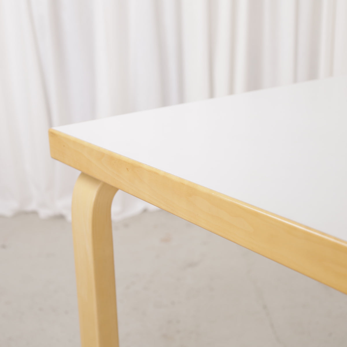 Alvar Aalto 82A table for Artek with white top and birch legs — tabletop edge and birch frame detail