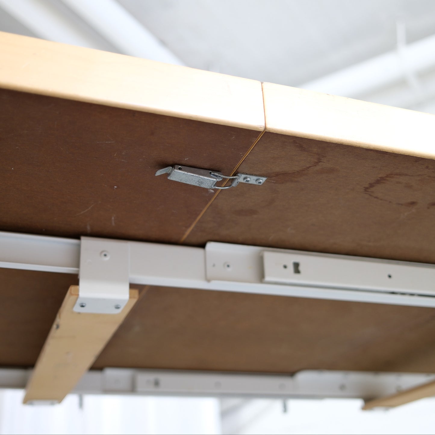 Underside of an Artek H99 table showing the extension mechanism