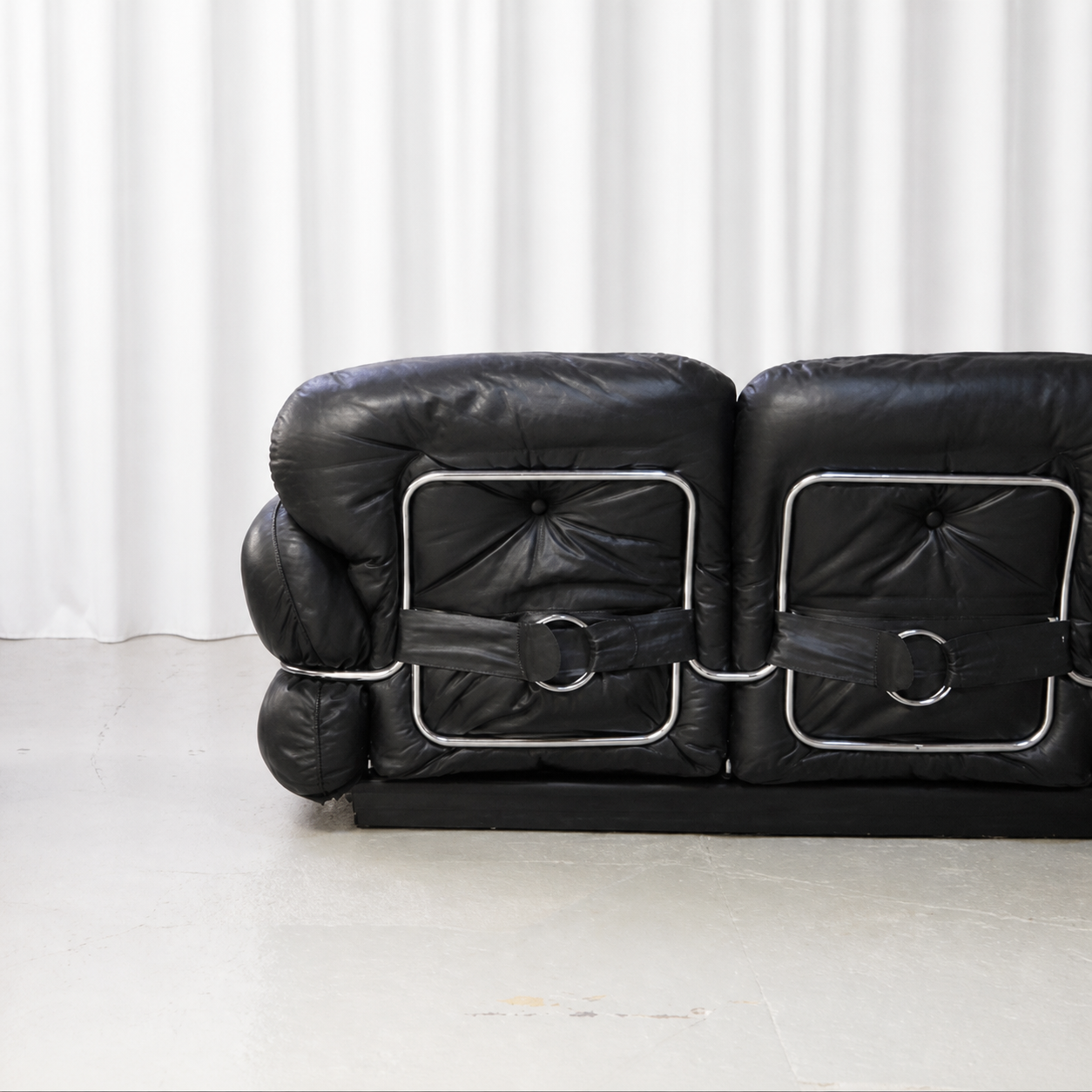Rear view of the 1970s Isku Hannibal two-seater sofa with black leather and chrome-steel frame.