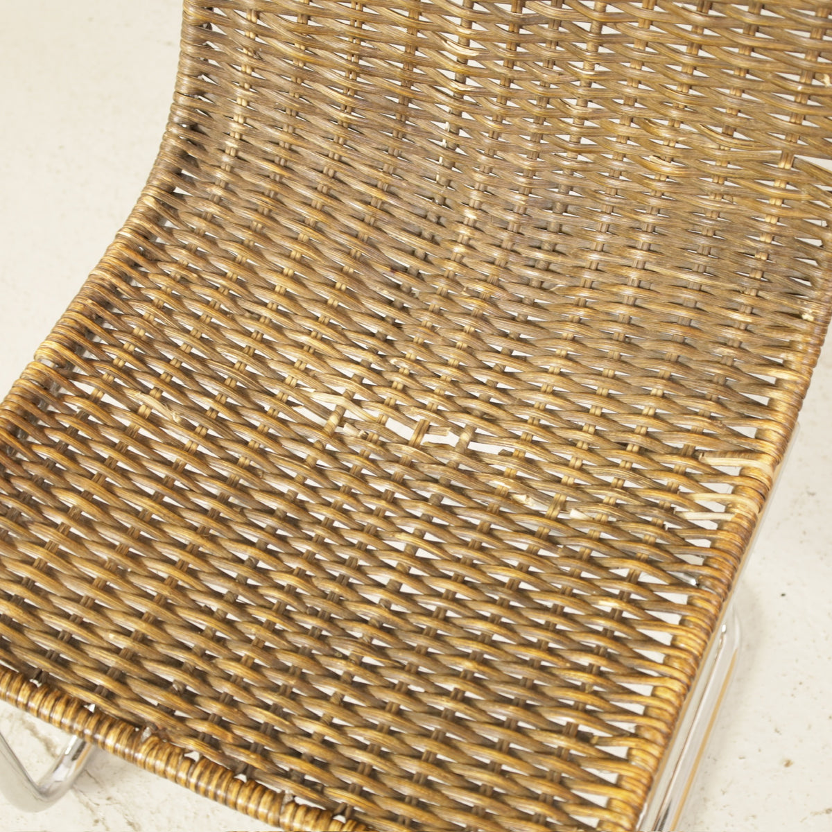Vintage Italian Chrome and Rattan Cantilever Chair, woven rattan seat detail with signs of use