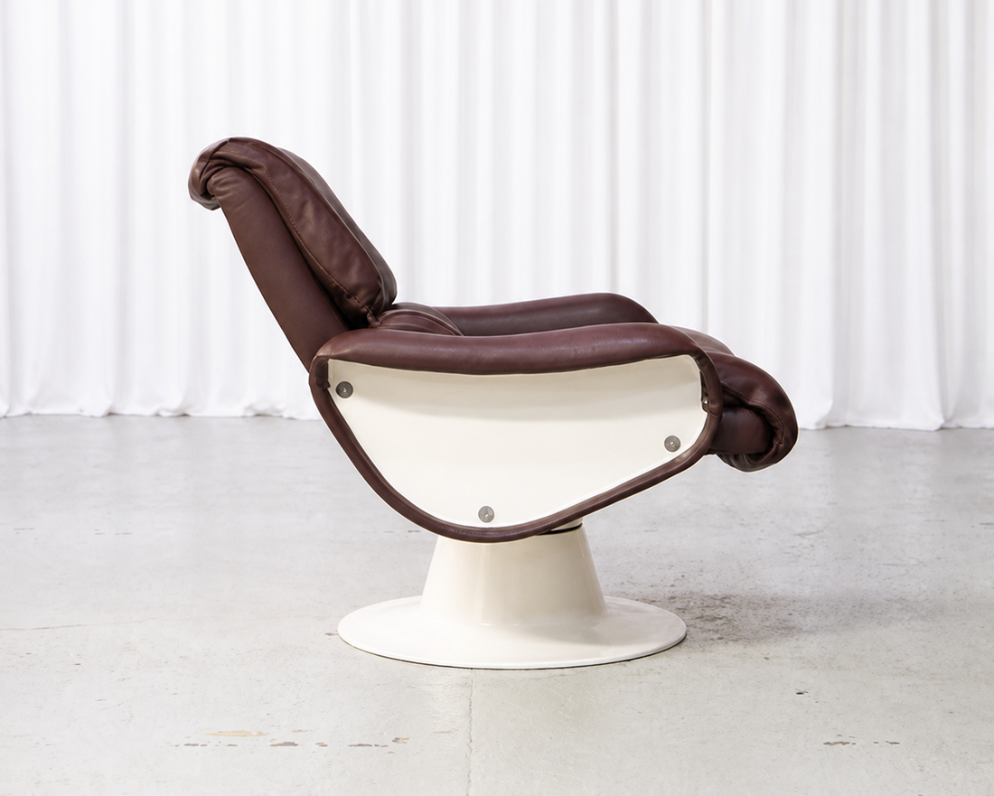 Vintage lounge chair upholstered in brown leather, side view