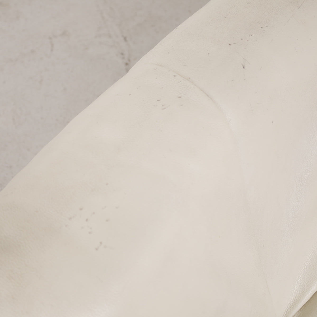 Close-up of small marks on cream leather upholstery