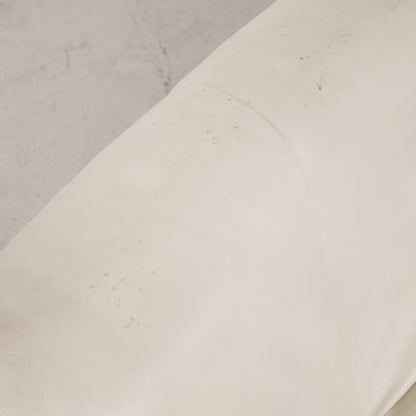 Close-up of small marks on cream leather upholstery
