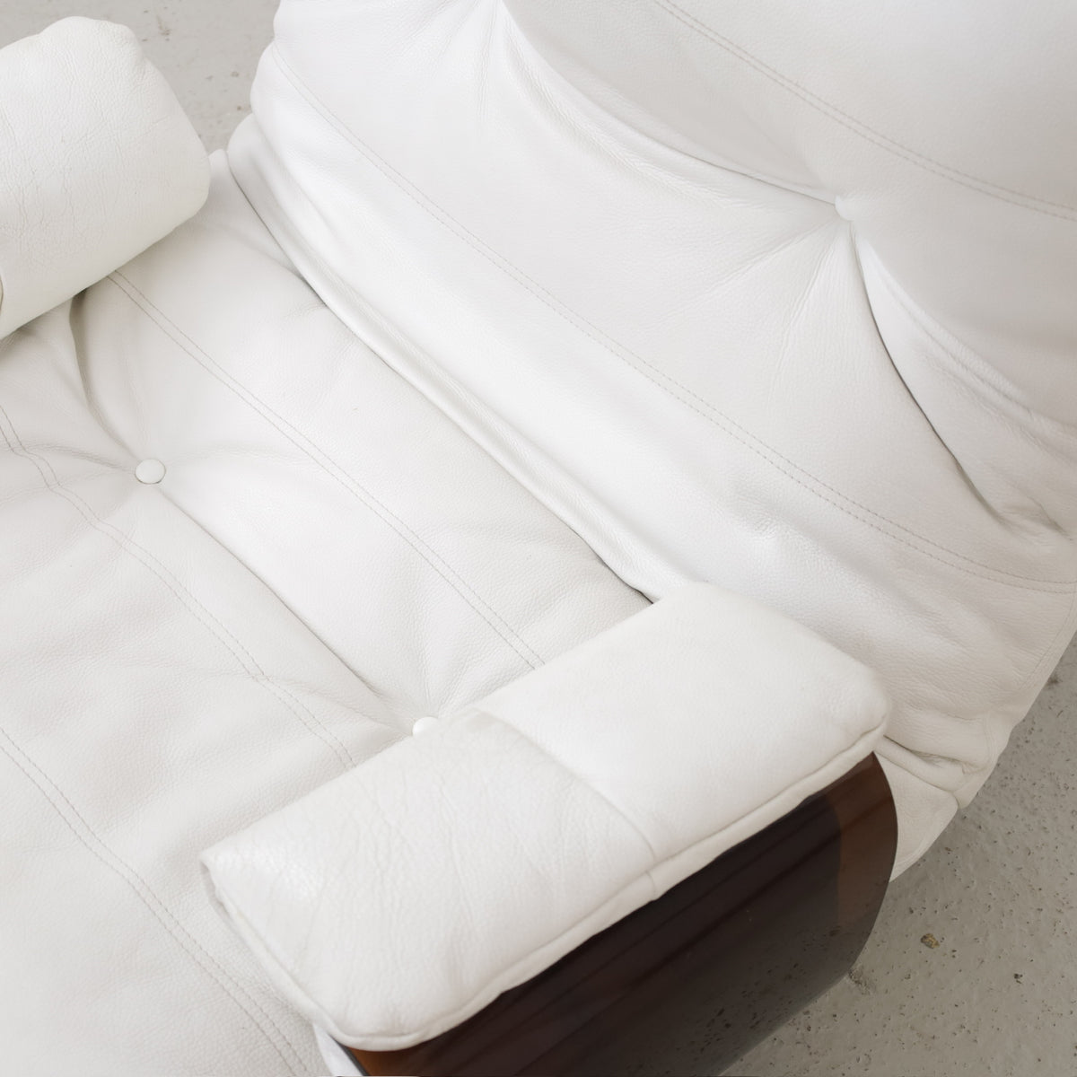 Detail of buttoned white seat and back upholstery