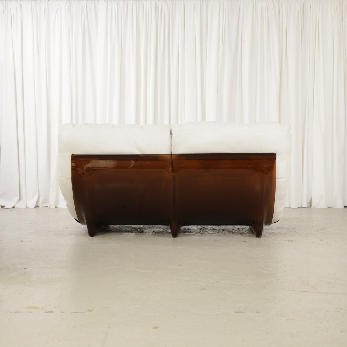 Rear view of the two-seater sofa with brown shell panels