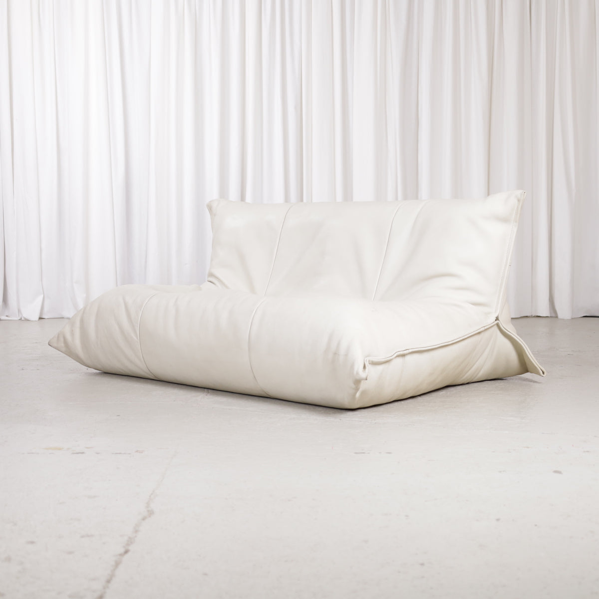 Ligne Roset Yoko two-seater sofa in cream leather, front three-quarter view