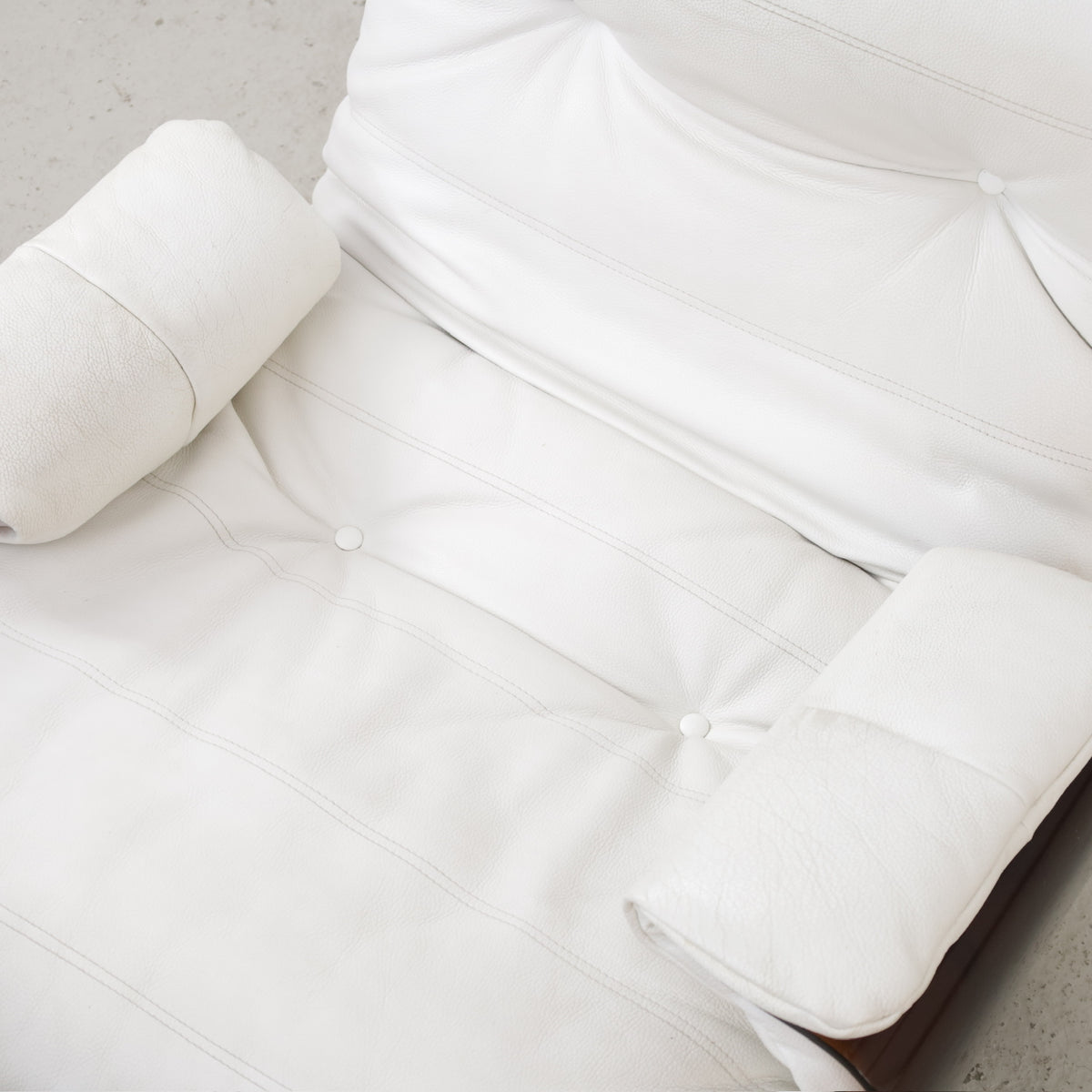 Detail of white upholstered chair seat