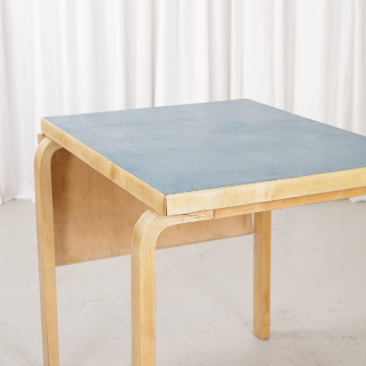 Alvar Aalto DL82 petrol blue linoleum tabletop, angled view