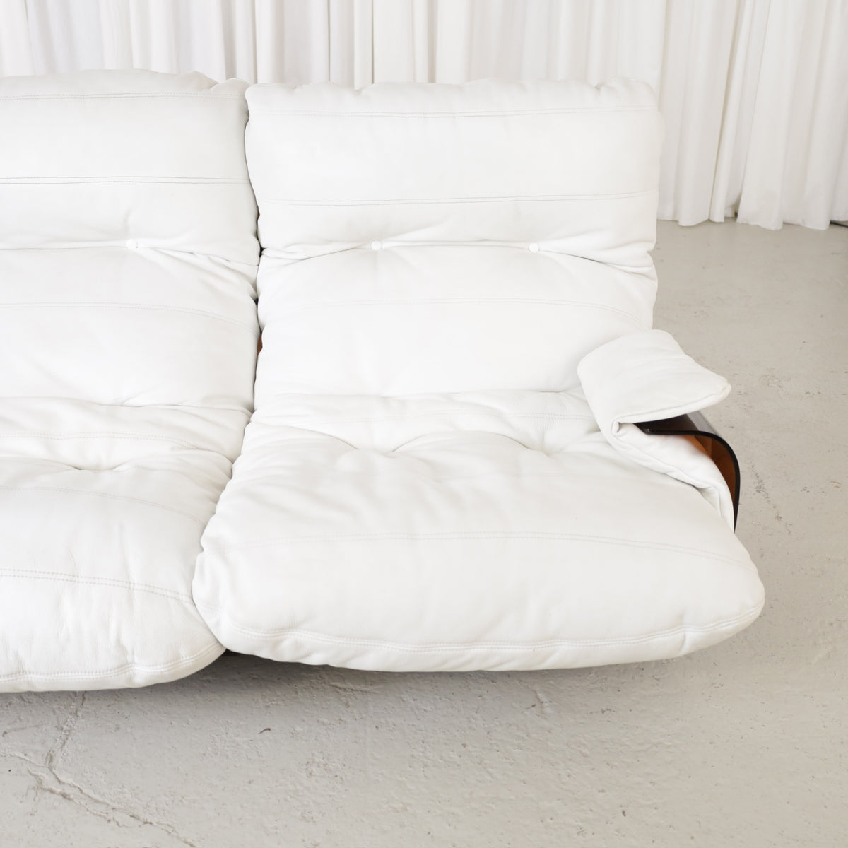 Close view of the right seat and buttoned white upholstery