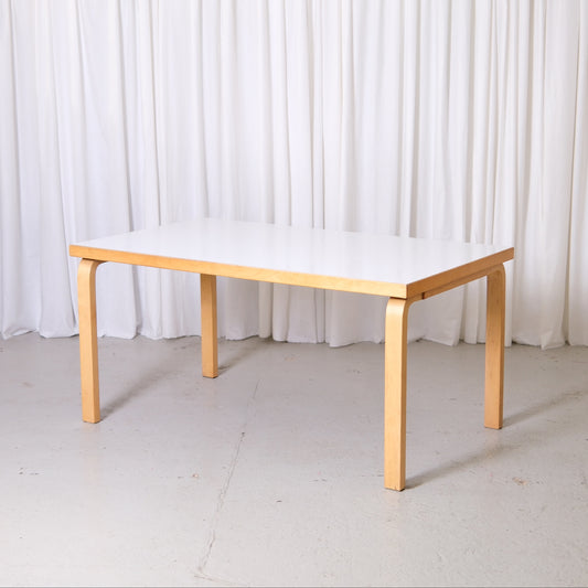 Vintage Artek 82A table by Alvar Aalto with white laminate top and birch legs. Finnish design classic from Helsinki with worldwide shipping available.