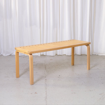 Artek 153A bench by Alvar Aalto in birch with slatted seat and bentwood legs.
