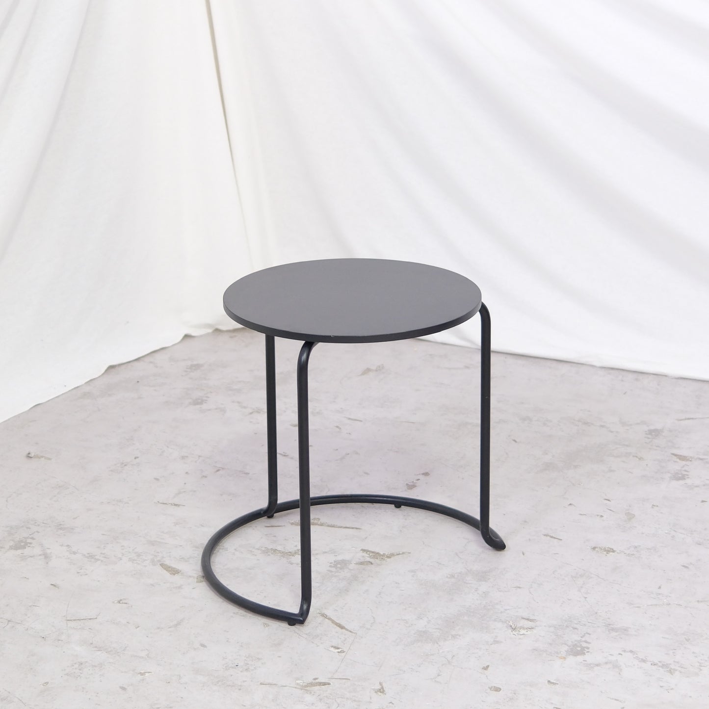 Vintage Artek 606 side table in all black. Compact round format ideal for sofa or bedside use. Available in Helsinki with worldwide shipping and delivery within Finland.