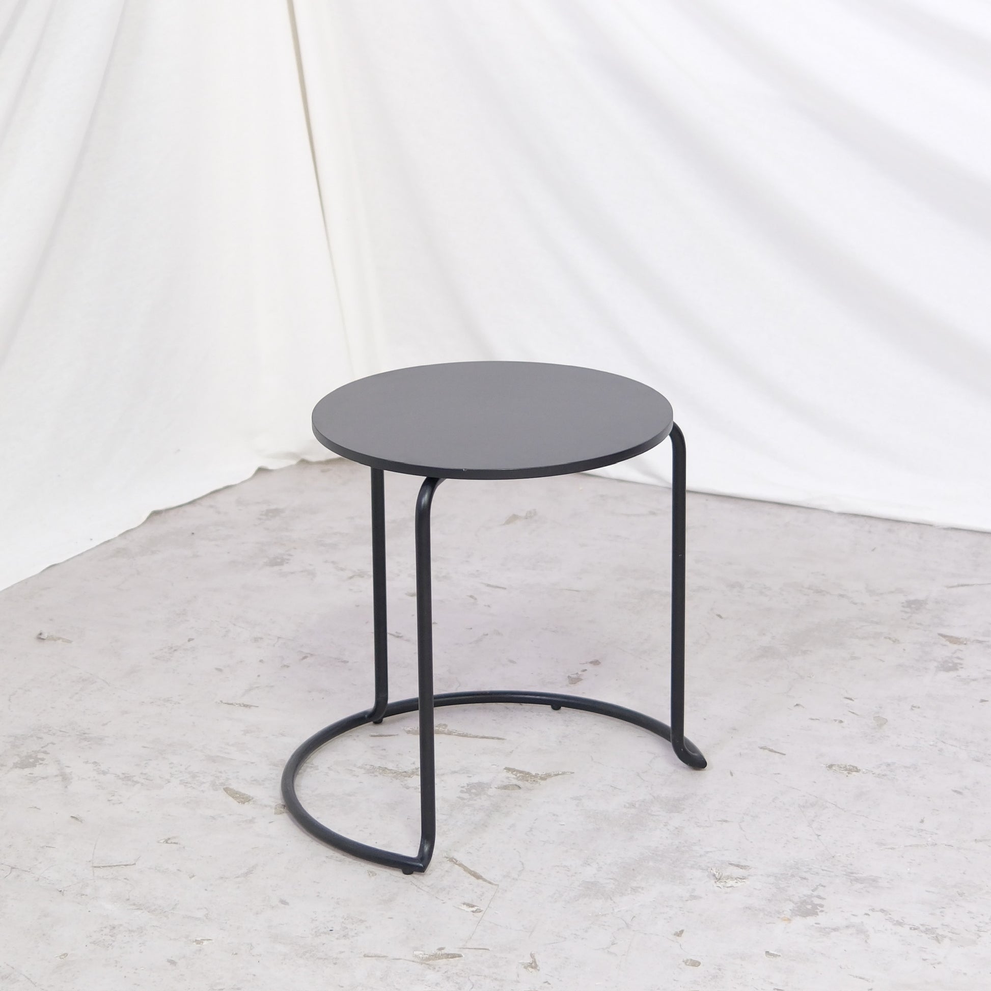 Vintage Artek 606 side table in all black. Compact round format ideal for sofa or bedside use. Available in Helsinki with worldwide shipping and delivery within Finland.
