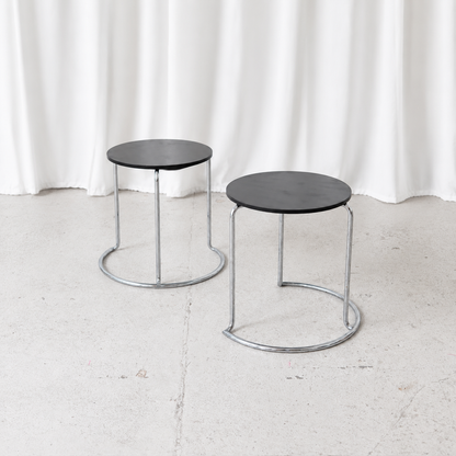 Vintage Artek 606 side table designed by Aino Aalto in 1932, featuring a black circular top and chromed tubular steel frame. A Finnish design classic.