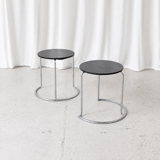 Vintage Artek 606 side table designed by Aino Aalto in 1932, featuring a black circular top and chromed tubular steel frame. A Finnish design classic.