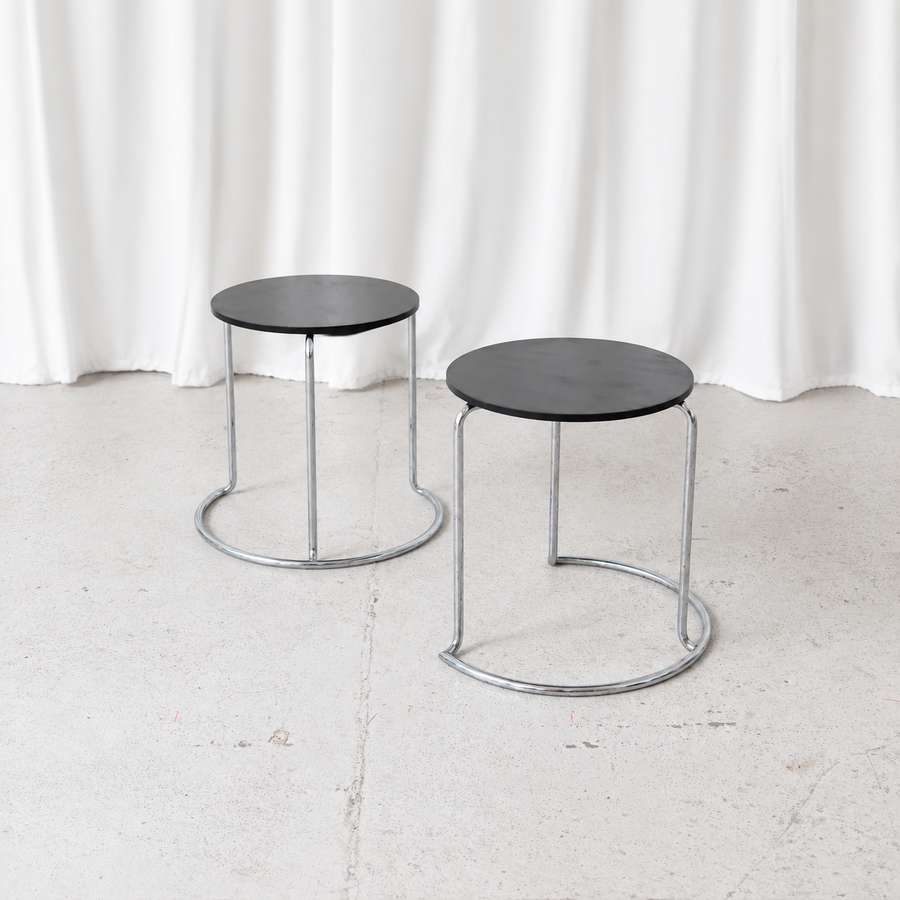 Vintage Artek 606 side table designed by Aino Aalto in 1932, featuring a black circular top and chromed tubular steel frame. A Finnish design classic.