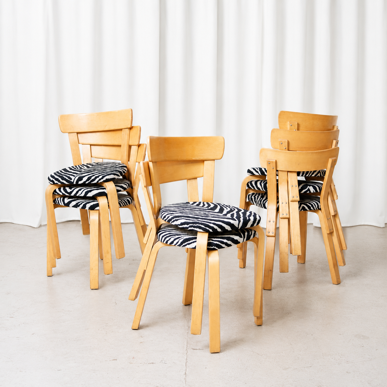 Vintage Artek Chair 69 by Alvar Aalto in natural birch with black-and-white zebra upholstery. Original chairs with visible patina and very clean upholstery.