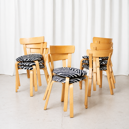 Vintage Artek Chair 69 by Alvar Aalto in natural birch with black-and-white zebra upholstery. Original chairs with visible patina and very clean upholstery.