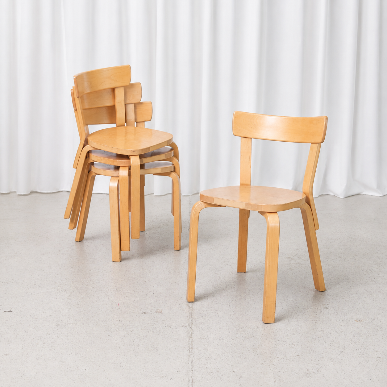 Vintage Artek Chair 69 in natural birch, designed by Alvar Aalto. Classic Finnish bentwood dining chair with visible signs of age and use.
