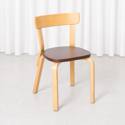 Vintage Artek Chair 69 designed by Alvar Aalto, featuring a birch frame and brown upholstered seat. Good condition with light wear on the wooden parts.