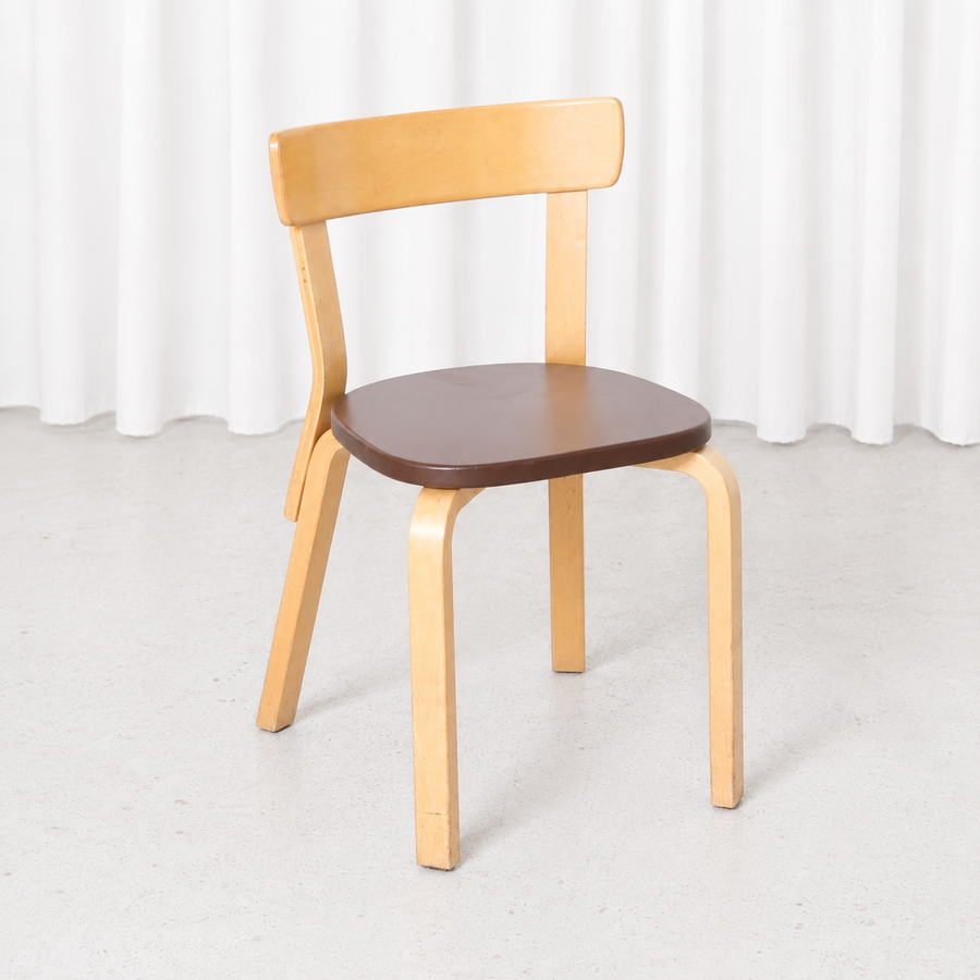 Vintage Artek Chair 69 designed by Alvar Aalto, featuring a birch frame and brown upholstered seat. Good condition with light wear on the wooden parts.