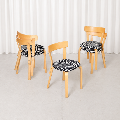 Vintage Artek Chair 69 by Alvar Aalto with zebra-patterned upholstery and a beautifully patinated birch frame. Sturdy, characterful Finnish design.