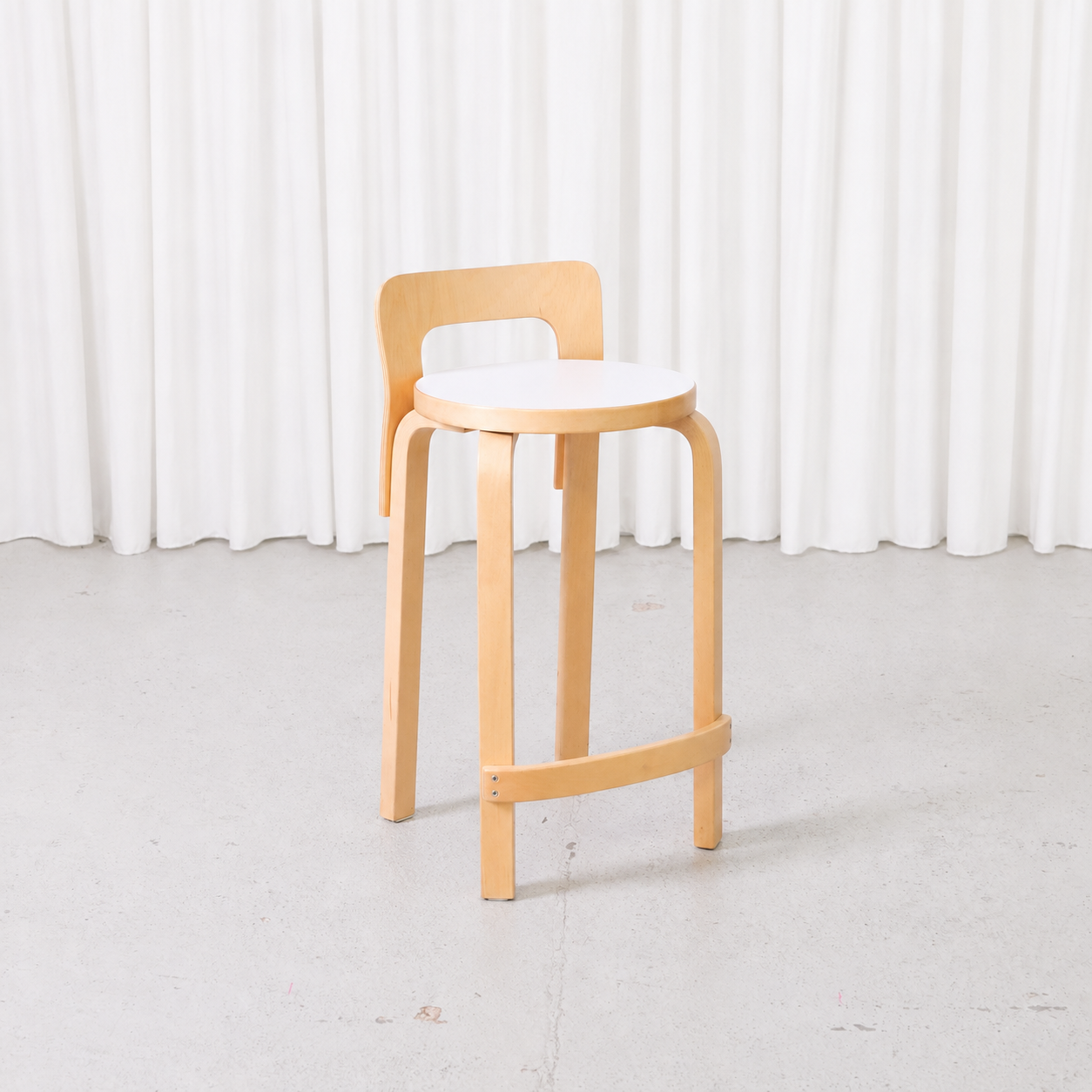 Artek K65 bar stool by Alvar Aalto with birch frame and white laminate seat