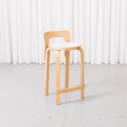 Artek K65 bar stool by Alvar Aalto with birch frame and white laminate seat