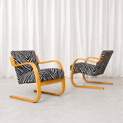 Vintage Artek Model 402 armchair by Alvar Aalto from the 1940s–1950s, featuring a beautifully patinated birch frame and zebra upholstery.