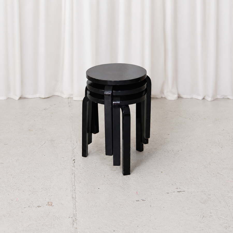 Vintage Artek Stool 60 by Alvar Aalto in later black paint. Iconic three-legged Finnish birch stool designed in 1933. Good, sturdy vintage condition.