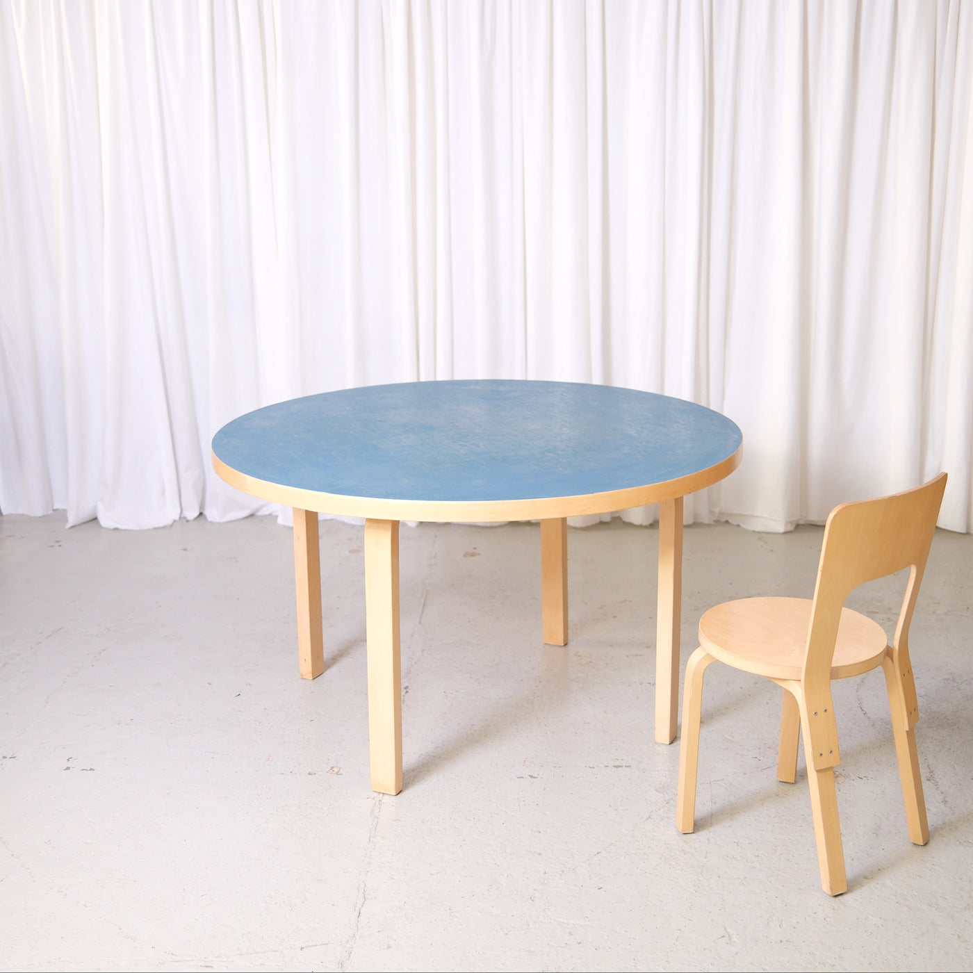 Vintage Artek Table 91 by Alvar Aalto with blue linoleum top and birch legs. Classic round Finnish design dining table, 125 cm diameter.
