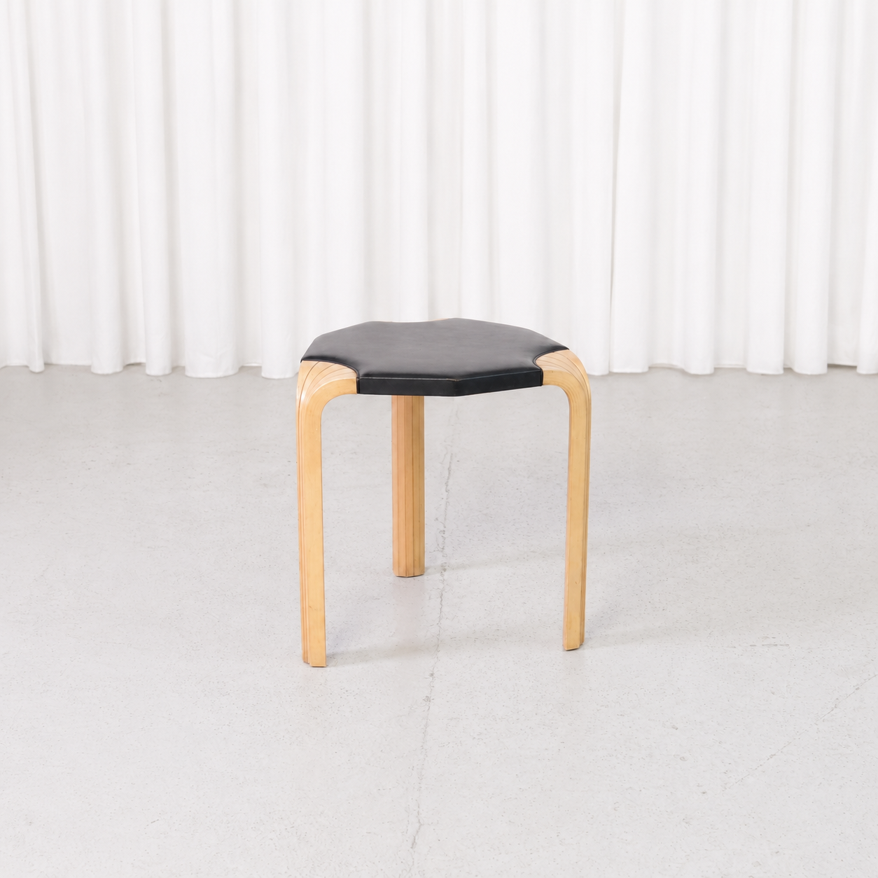 Artek X602 stool by Alvar Aalto with birch fan legs and black leather seat