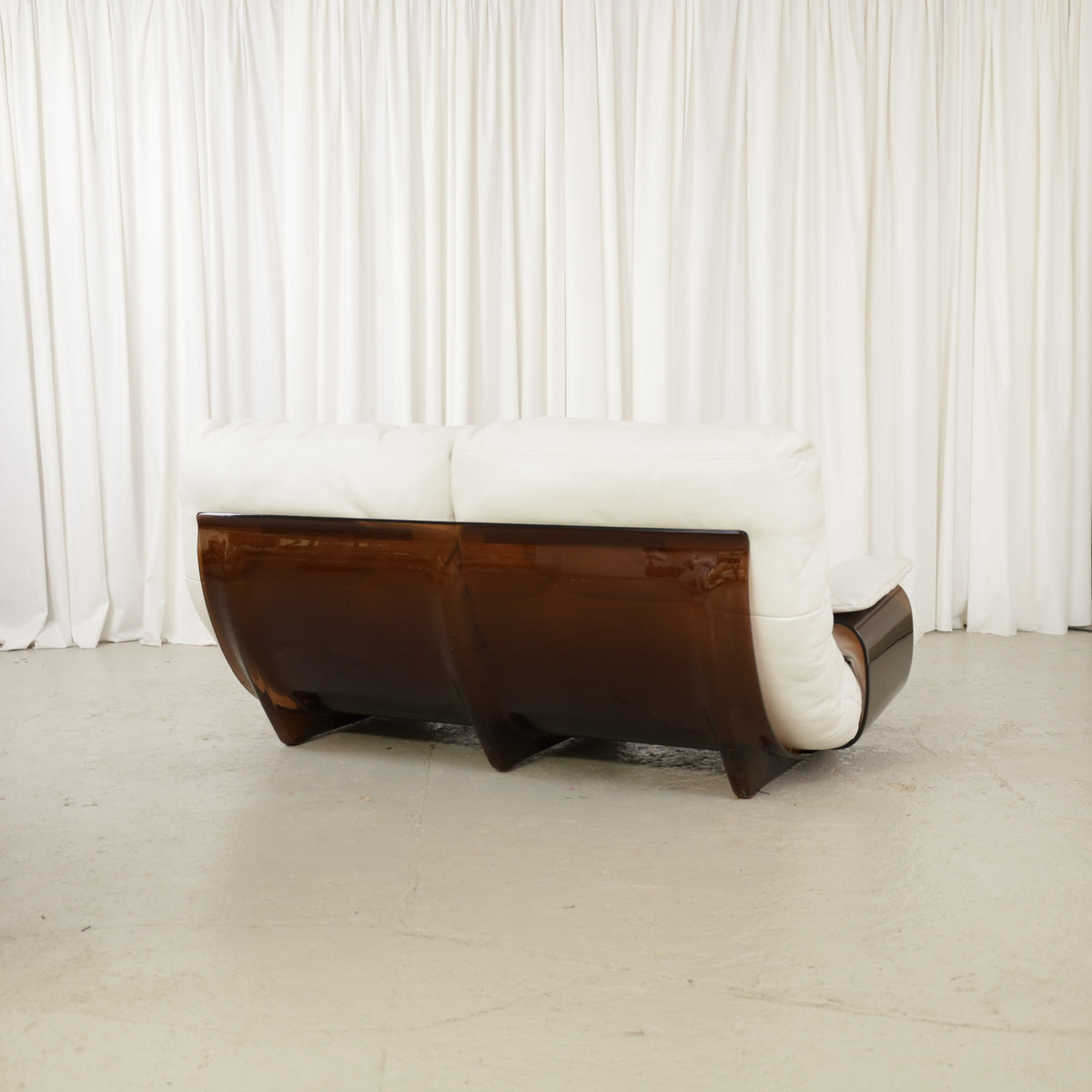 Rear angled view of the two-seater sofa and brown curved shell