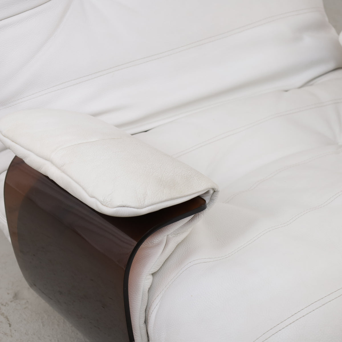 Detail of padded armrest and seat upholstery