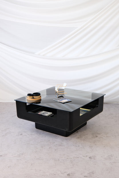 Eero Aarnio black fiberglass coffee table with smoked glass top and integrated storage, 1970s Finnish design.
