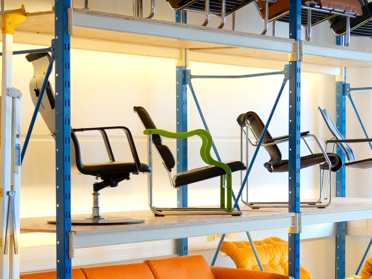 Vintage design chairs displayed on shelving at Pino Interiors in Helsinki