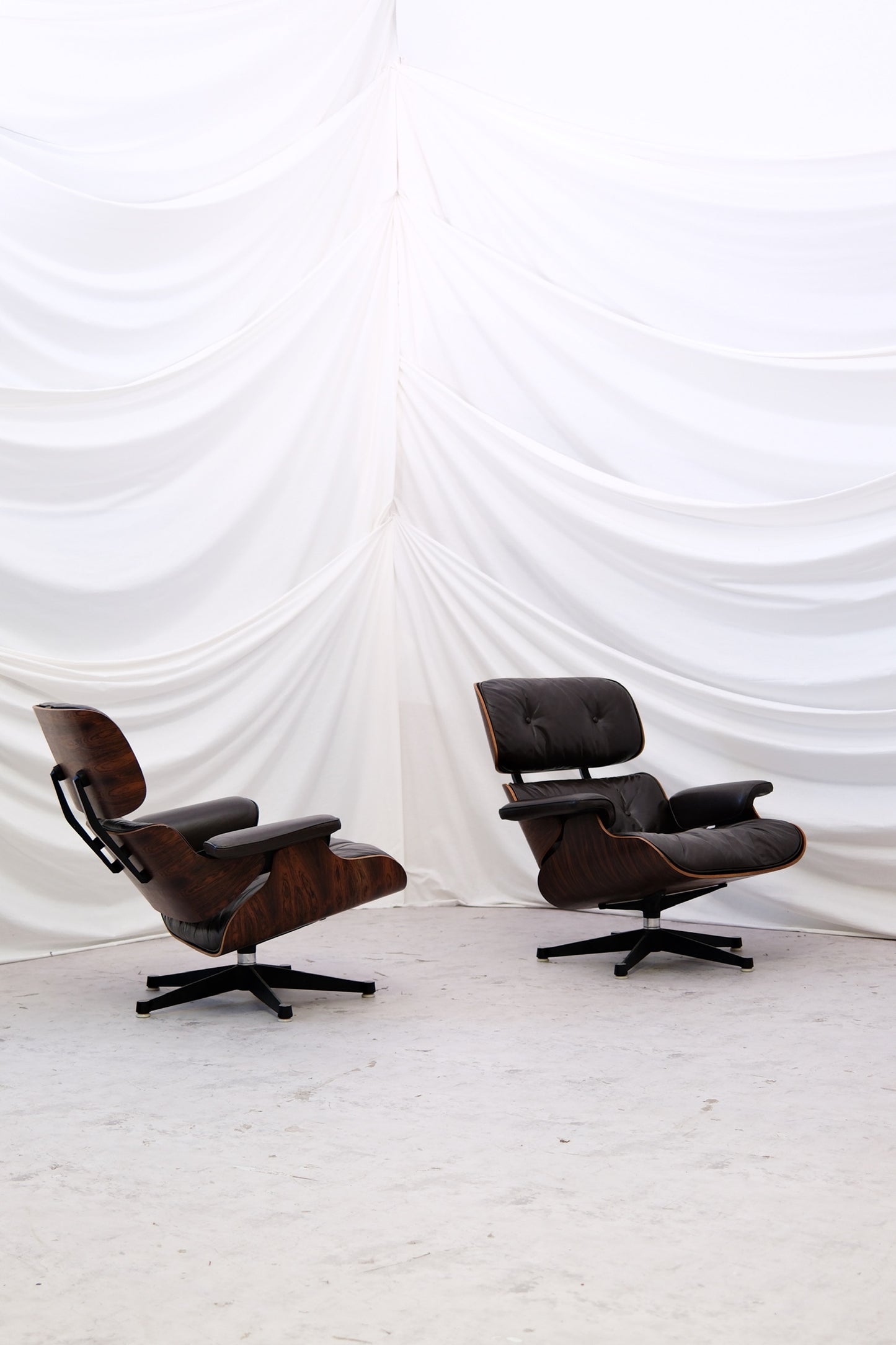 Vintage Eames Lounge Chair pair designed by Charles and Ray Eames. Mobilier International licensed production with dark brown leather and rosewood frames. Worldwide shipping available.
