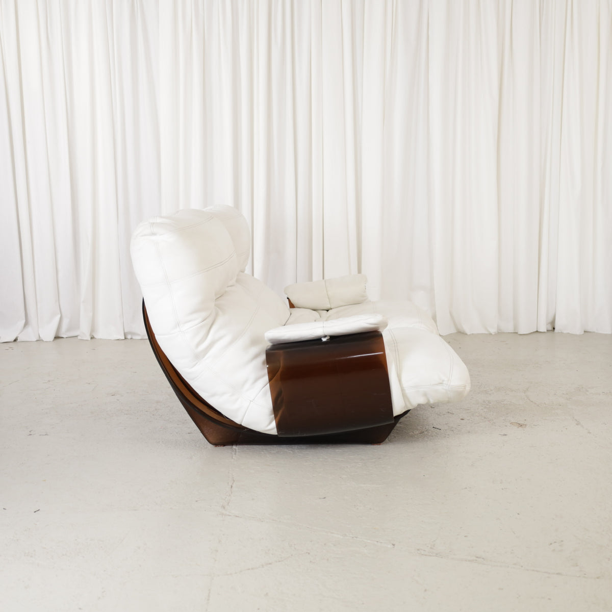 Side view of white upholstered Marsala two-seater sofa with brown curved shell
