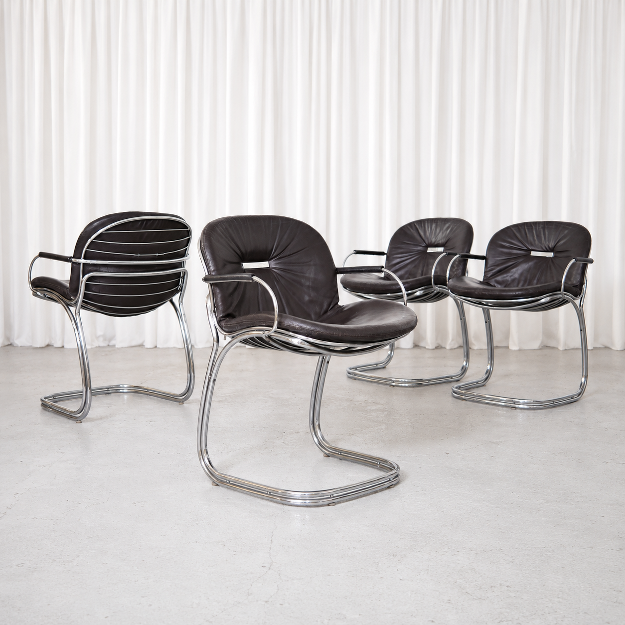 Vintage Sabrina chairs by Gastone Rinaldi for RIMA, Italy, circa 1970. Black leather upholstery with sculptural chrome cantilever frames.
