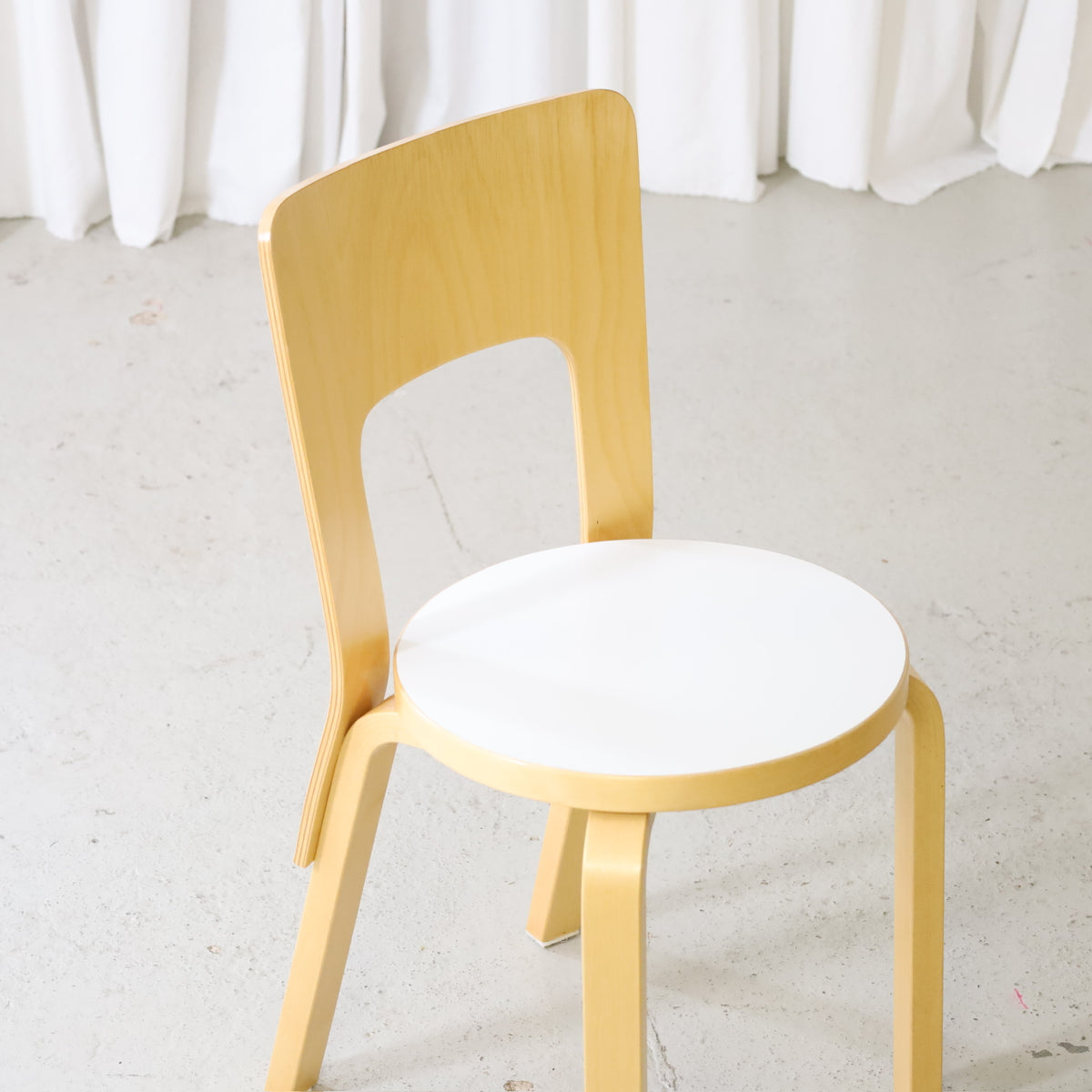 Artek Chair 66 in birch with white laminate seat, elevated angled view