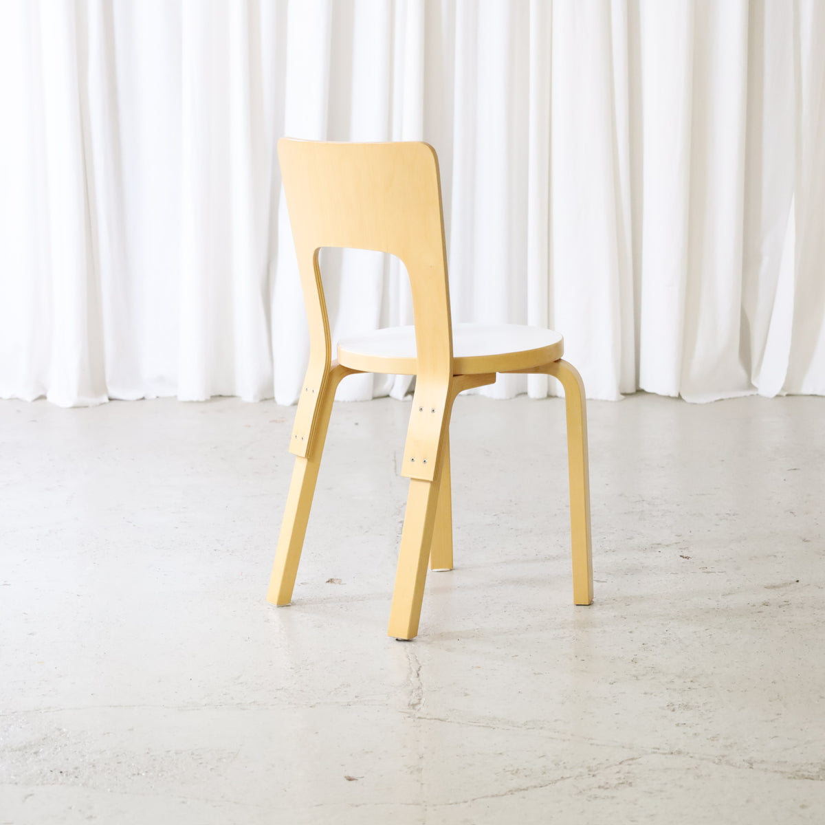 Artek Chair 66 in birch with white laminate seat, rear angled view