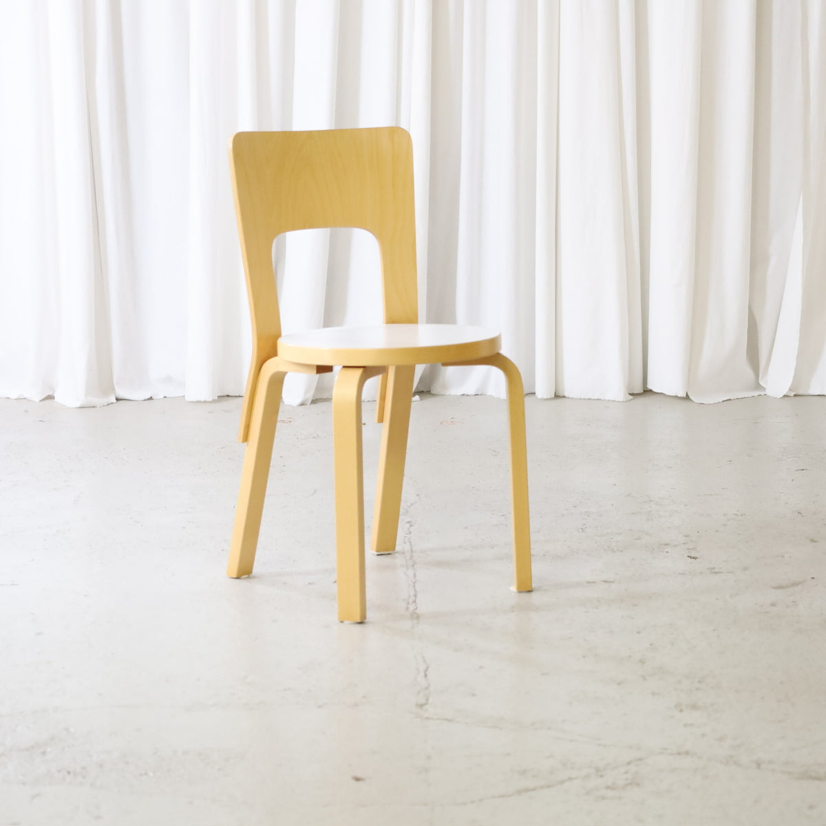 Artek Chair 66 in birch with white laminate seat, front view