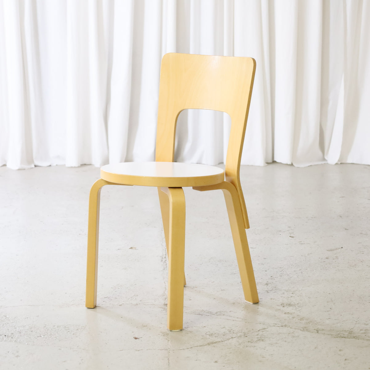 Artek Chair 66 in birch with white laminate seat, front angled view