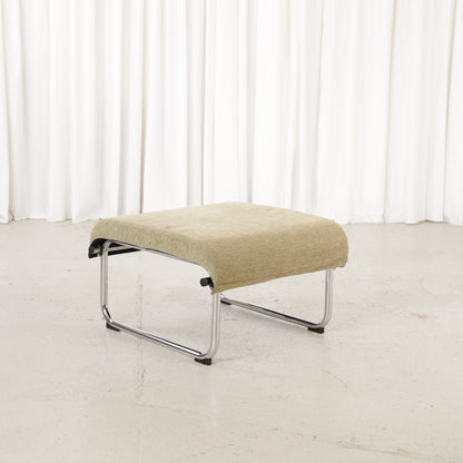 Remmi ottoman with chrome frame, angled view