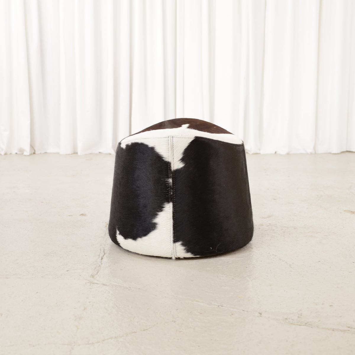 Niels Gammelgaard IKEA Stockholm cowhide swivel ottoman – End view with seam