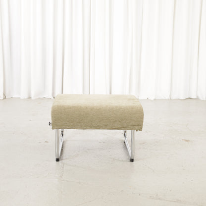 Matching Remmi ottoman in green fabric, front view