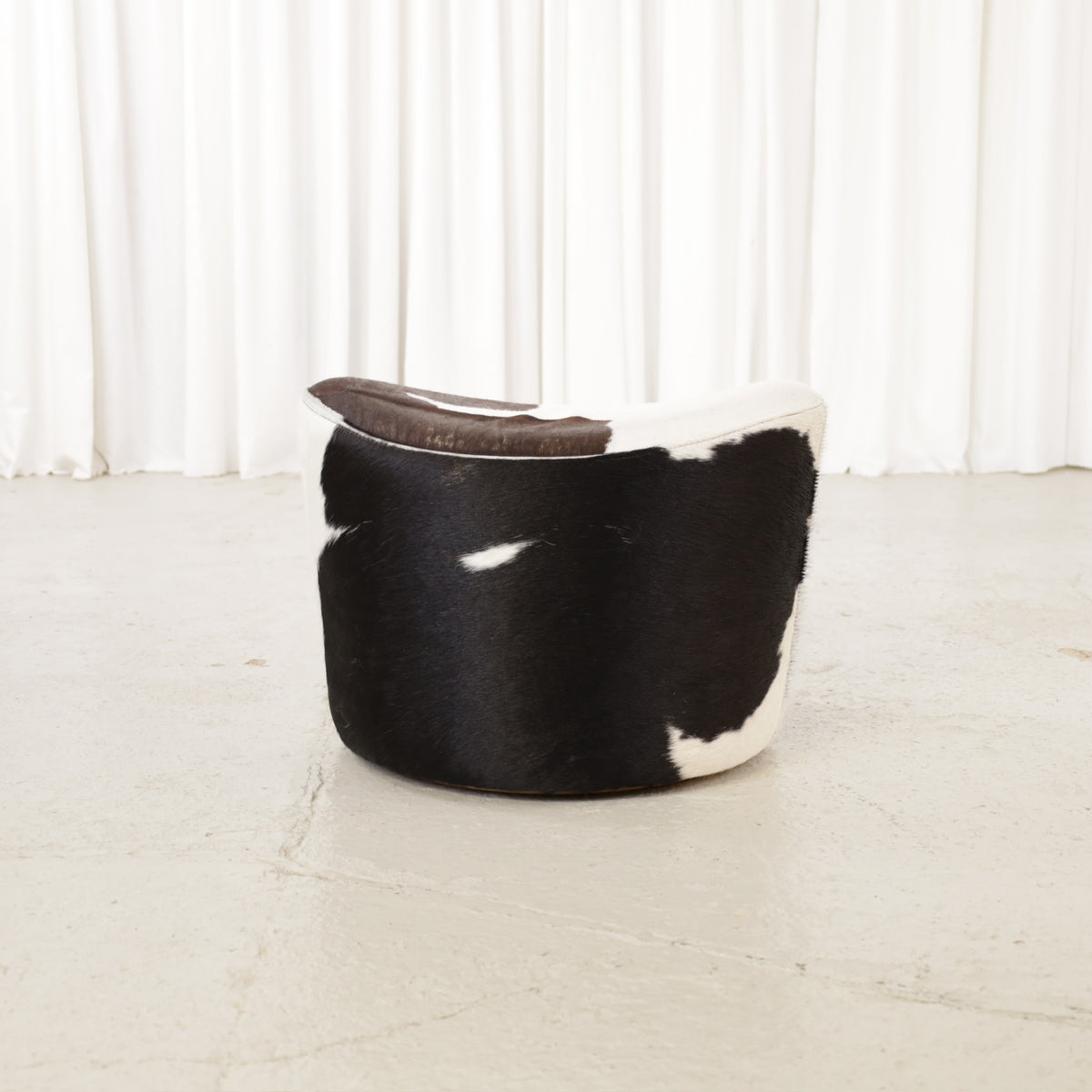 Niels Gammelgaard IKEA Stockholm cowhide swivel ottoman – Opposite angled view