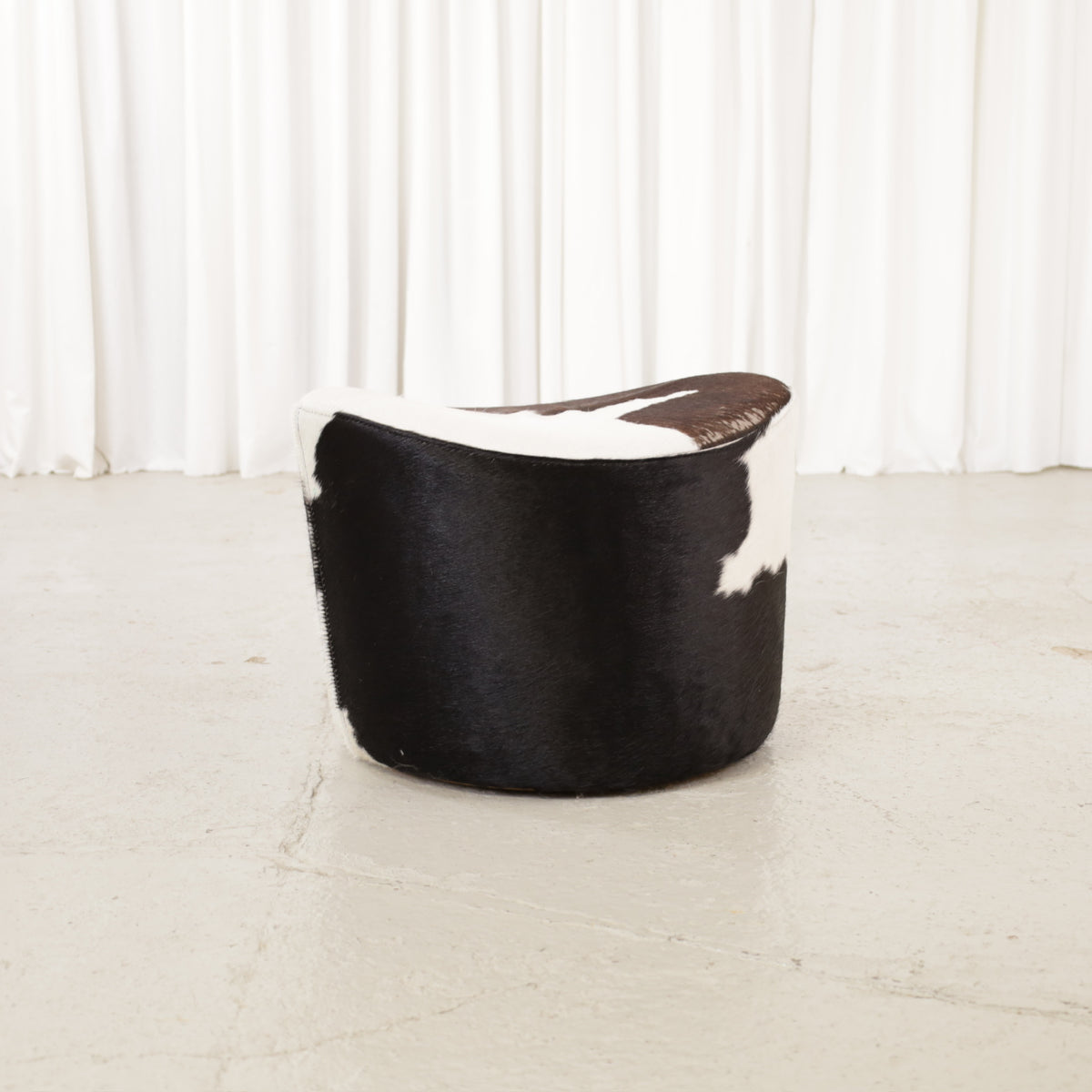 Niels Gammelgaard IKEA Stockholm cowhide swivel ottoman – Front angled view