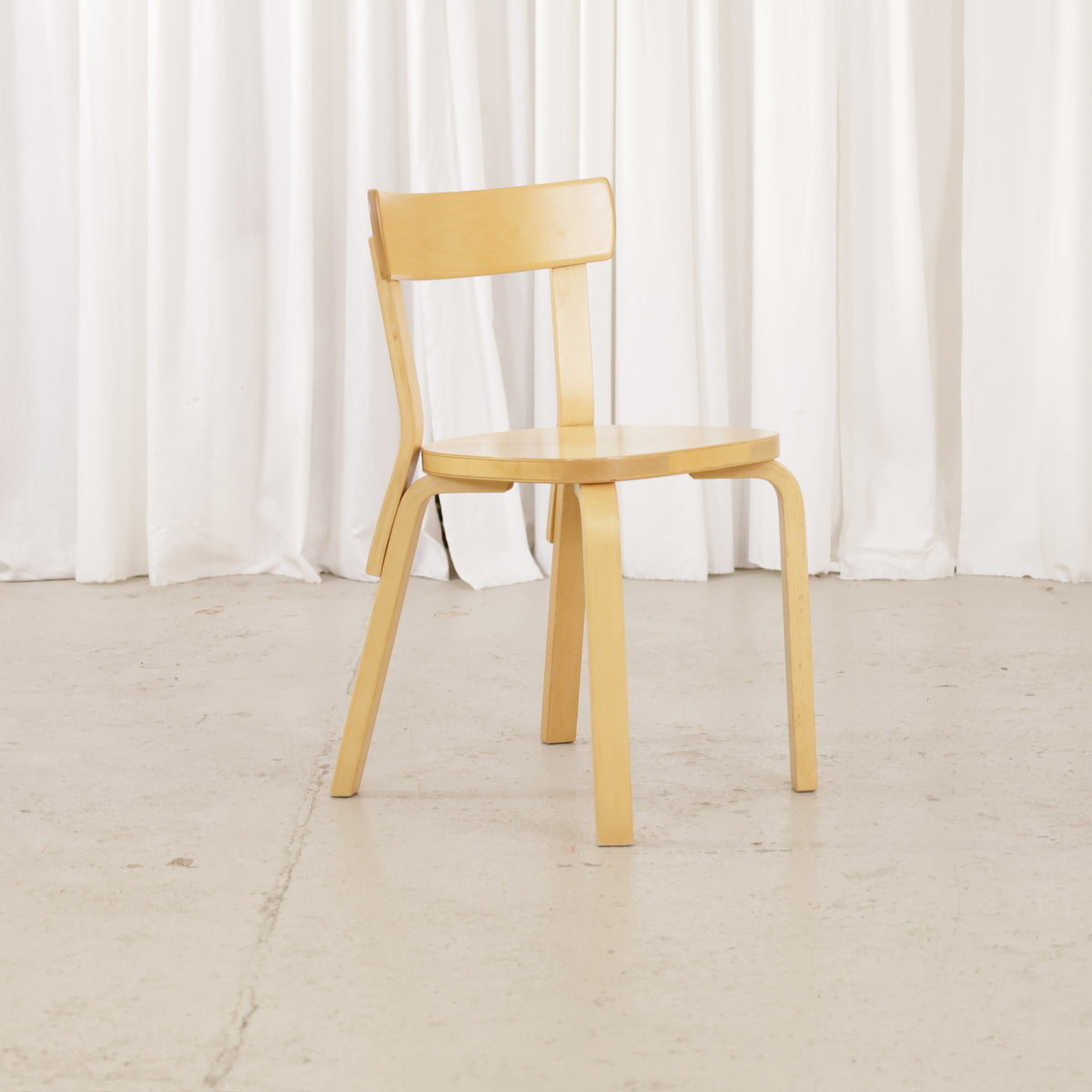 Artek Chair 69 in warm patinated birch, angled front view
